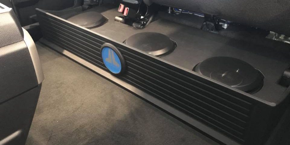 Ford F250 subwoofer box installation under rear seat by Explicit Customs Melbourne FL